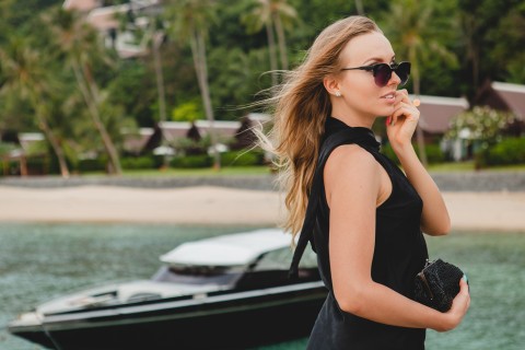 Stylish escort stepping onto a private jet