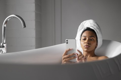 Escort relaxing in bathtub, balancing life