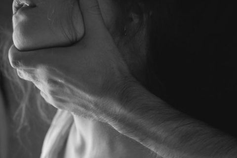 Teen covering neck, illustrating sexual choking risks