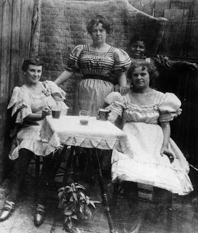 Wild West courtesans outside frontier saloon