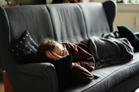 escort burnout woman lying on couch