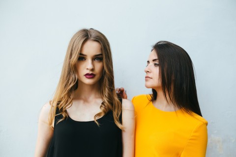Escort vs girlfriend standing together