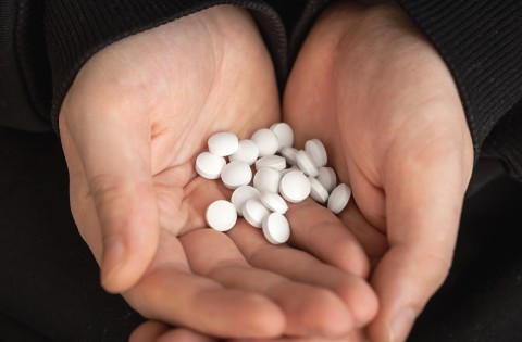 Illegal potency enhancers pills in hand