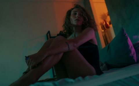 Professional escort woman resting comfortably in bed