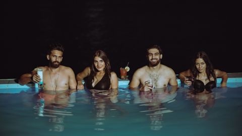 Couples relaxing before partner swap escort date pool