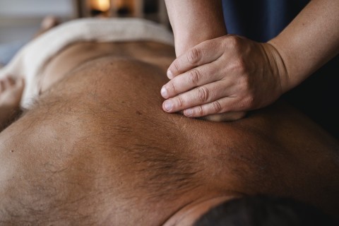 A man receiving a prostate massage treatment.