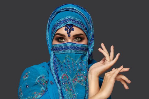 A Middle Eastern woman looking seductively, representing prostitution in the Arab world.