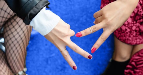 Female escort and woman client in intimate scissoring moment