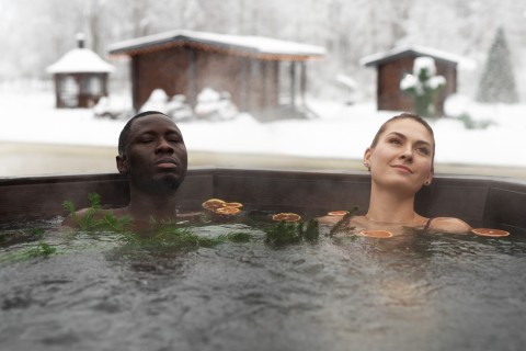 Couple relaxing close in bubbling hot tub