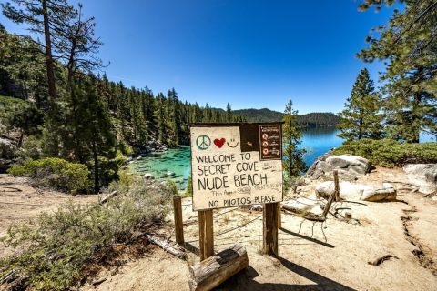 Sunny secluded nudist beach with calm blue water