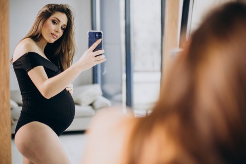 Pregnant escort woman with soft glow