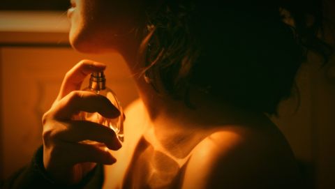 Woman choosing signature scent perfume collection escort