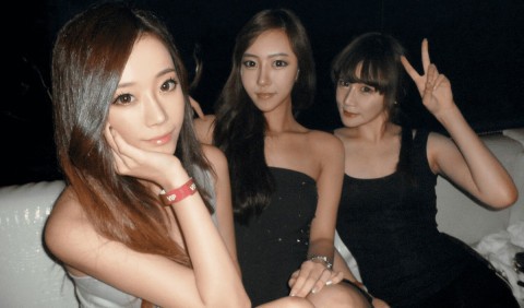 Three South Korea escorts in city nightlife.