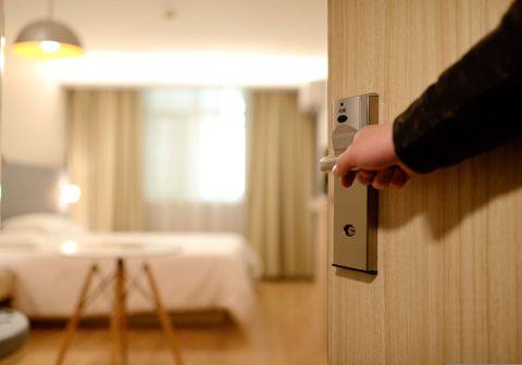 Man entering a hotel room to meet an escort.