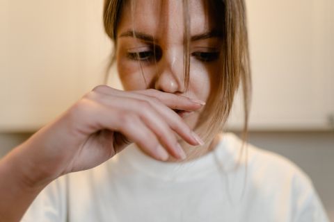 Woman reacting to unpleasant semen smell