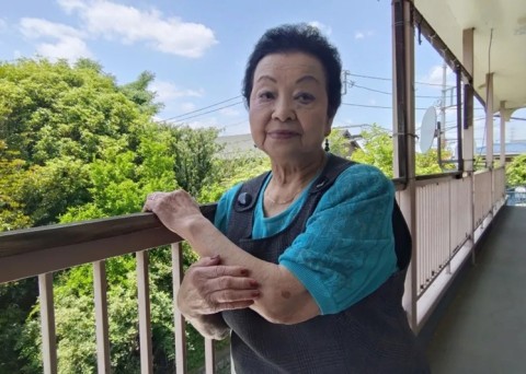 Elderly Japanese woman Yuko Ogasawara smiling confidently.