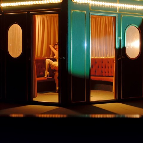 Peep show performer entertaining audience.