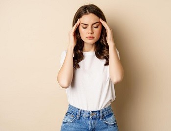 Sex worker sitting alone, looking distressed.