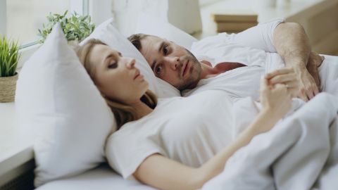 Sexless marriage crisis affecting one in three American couples sitting apart on a couch