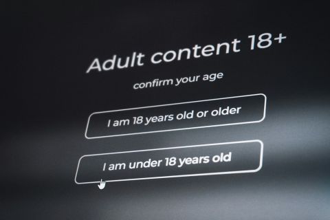 Person using age verification app on their phone in everyday setting