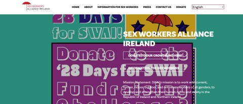 Sex workers and allies protest in Dublin for rights and SWAI funding, holding signs demanding protection and justice.