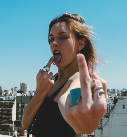 Escort showing middle finger as a bold message to restrictive payment services.