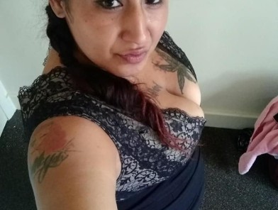Curvy escort in soft lighting