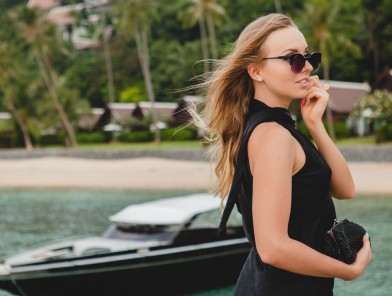 Stylish escort stepping onto a private jet