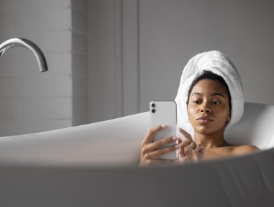 Escort relaxing in bathtub, balancing life