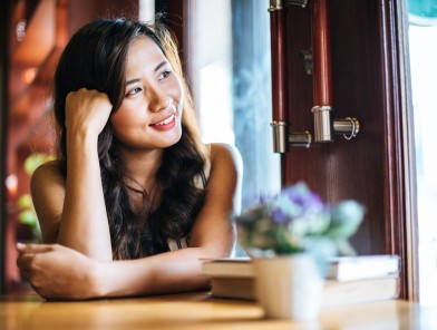 Young Asian woman smiling confidently.