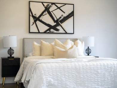 Cozy bedroom with warm lighting creating an intimate incall atmosphere.