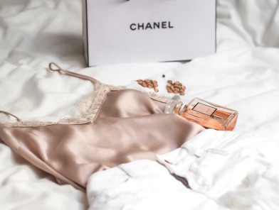 Escort unwrapping received gifts on a bed