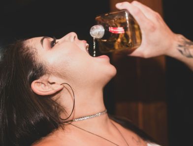 Escort woman drinking too much alcohol at late night booking