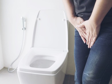 Escort UTI prevention woman holding lower abdomen