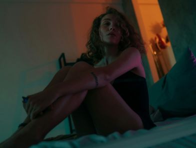Professional escort woman resting comfortably in bed