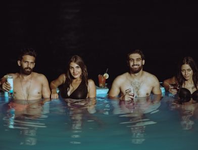 Couples relaxing before partner swap escort date pool