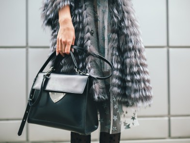 perfect escort bag essentials - cover elegant woman holding an escort bag confidently