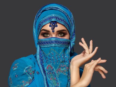 A Middle Eastern woman looking seductively, representing prostitution in the Arab world.