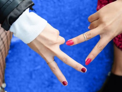 Female escort and woman client in intimate scissoring moment