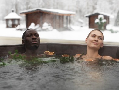Couple relaxing close in bubbling hot tub