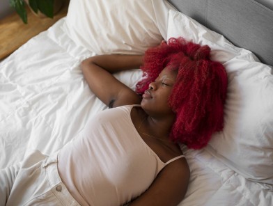 Woman sleeping, experiencing sexual dreams