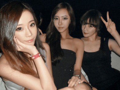 Three South Korea escorts in city nightlife.