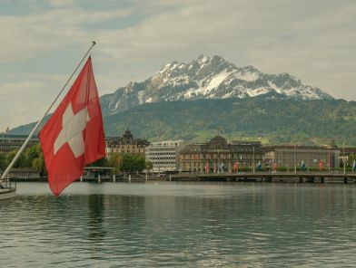Swiss flag overlooking alpine escort market.