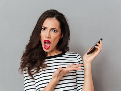 Escort looking disappointed at vulgar text message