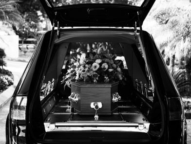 Hearse carrying coffin of deceased spouse