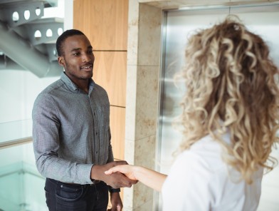 Two colleagues holding hands and connecting romantically