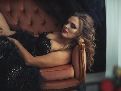 Luxury escort lying on hotel couch