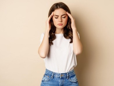 Sex worker sitting alone, looking distressed.
