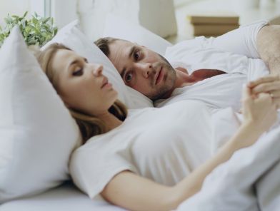 Sexless marriage crisis affecting one in three American couples sitting apart on a couch