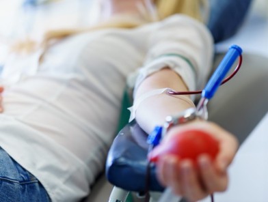 Diverse people including LGBTQIA+ and sex workers surrounding a plasma bag, symbolizing ACT’s removal of plasma donation bans for inclusivity and safety.